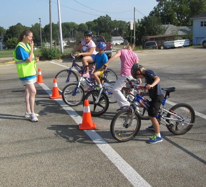 Bike Rodeo 2- Karla Organist helps students at a Bike Rodeo station ...